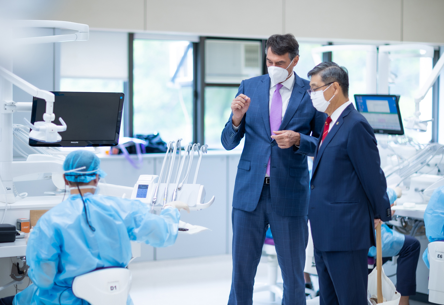 Professor Flemmig explains to Dr Patrick Poon